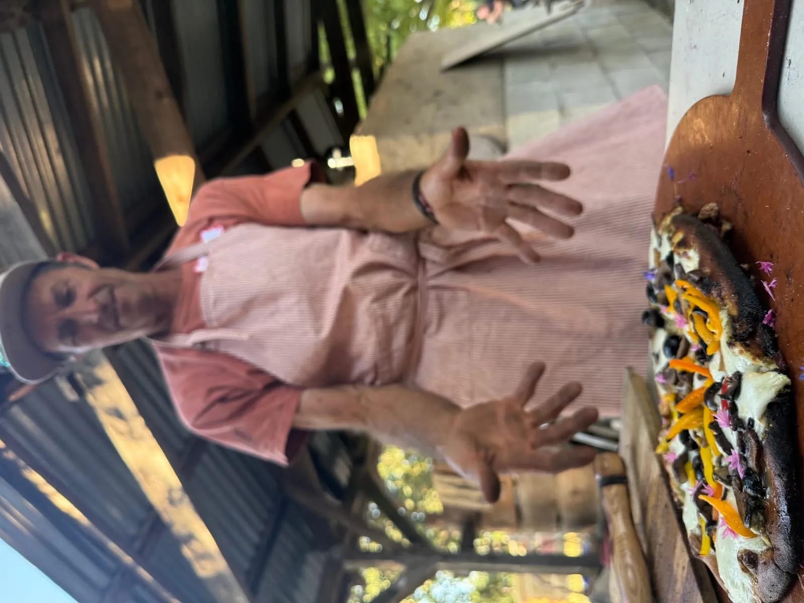 Chef presenting wood-fired pizza