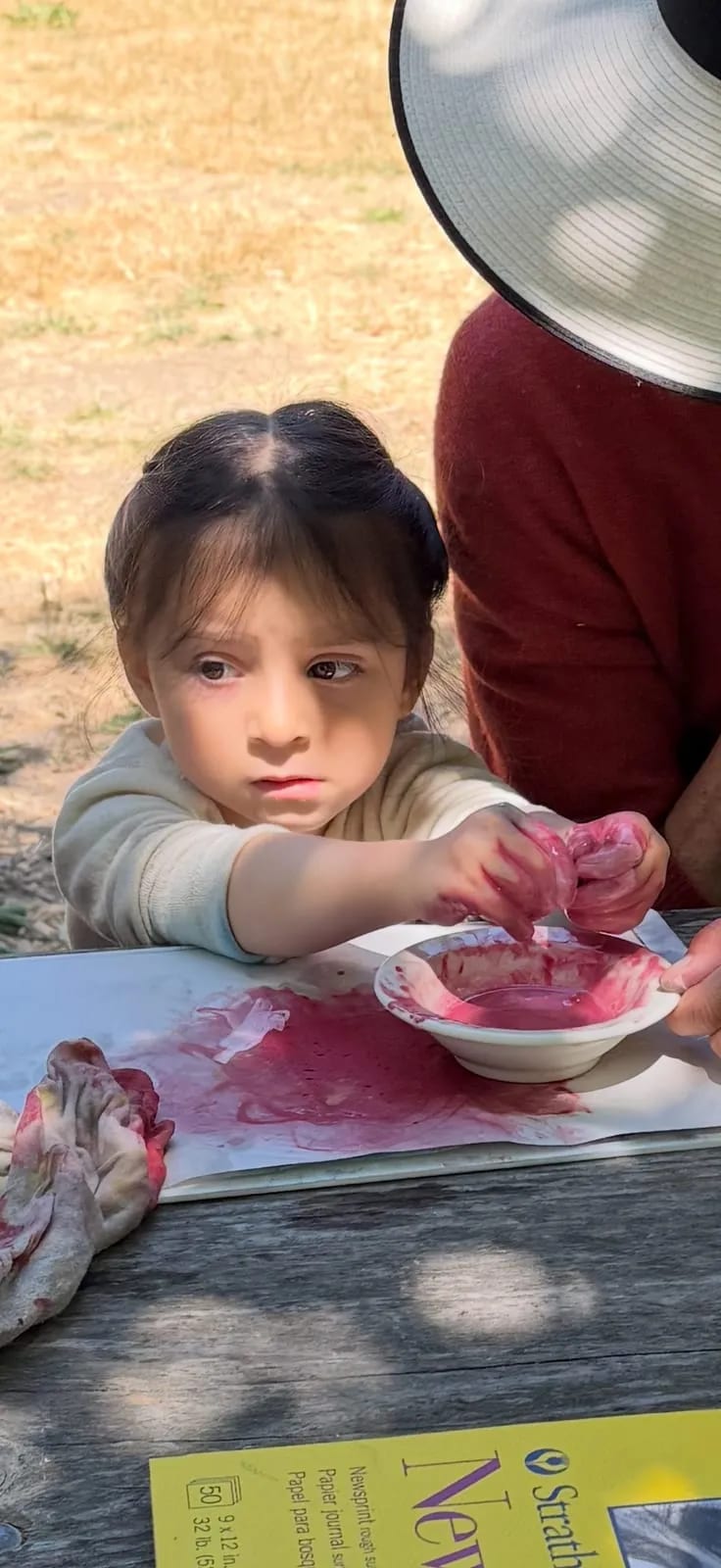 Toddler mixing pink dye