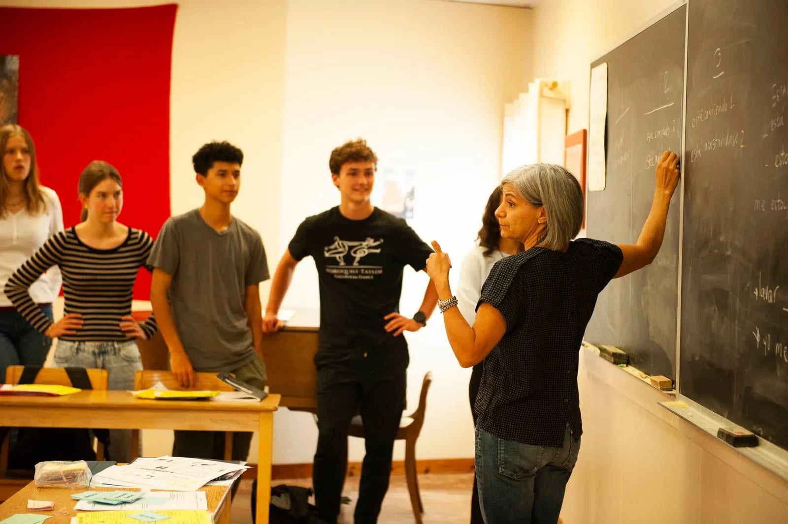 Spanish class at the board, working through verb forms.