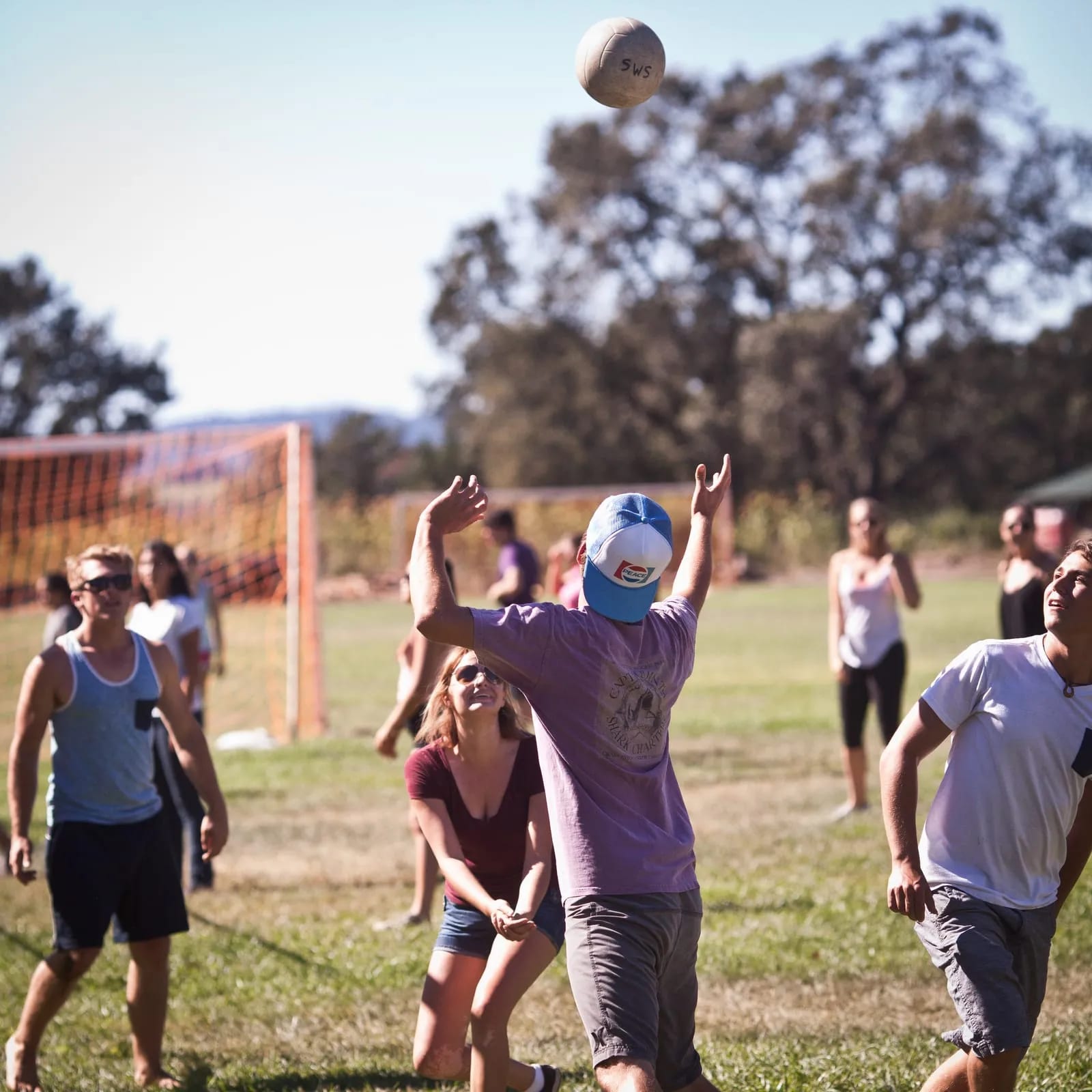 A pick-up volleyball game on the field.