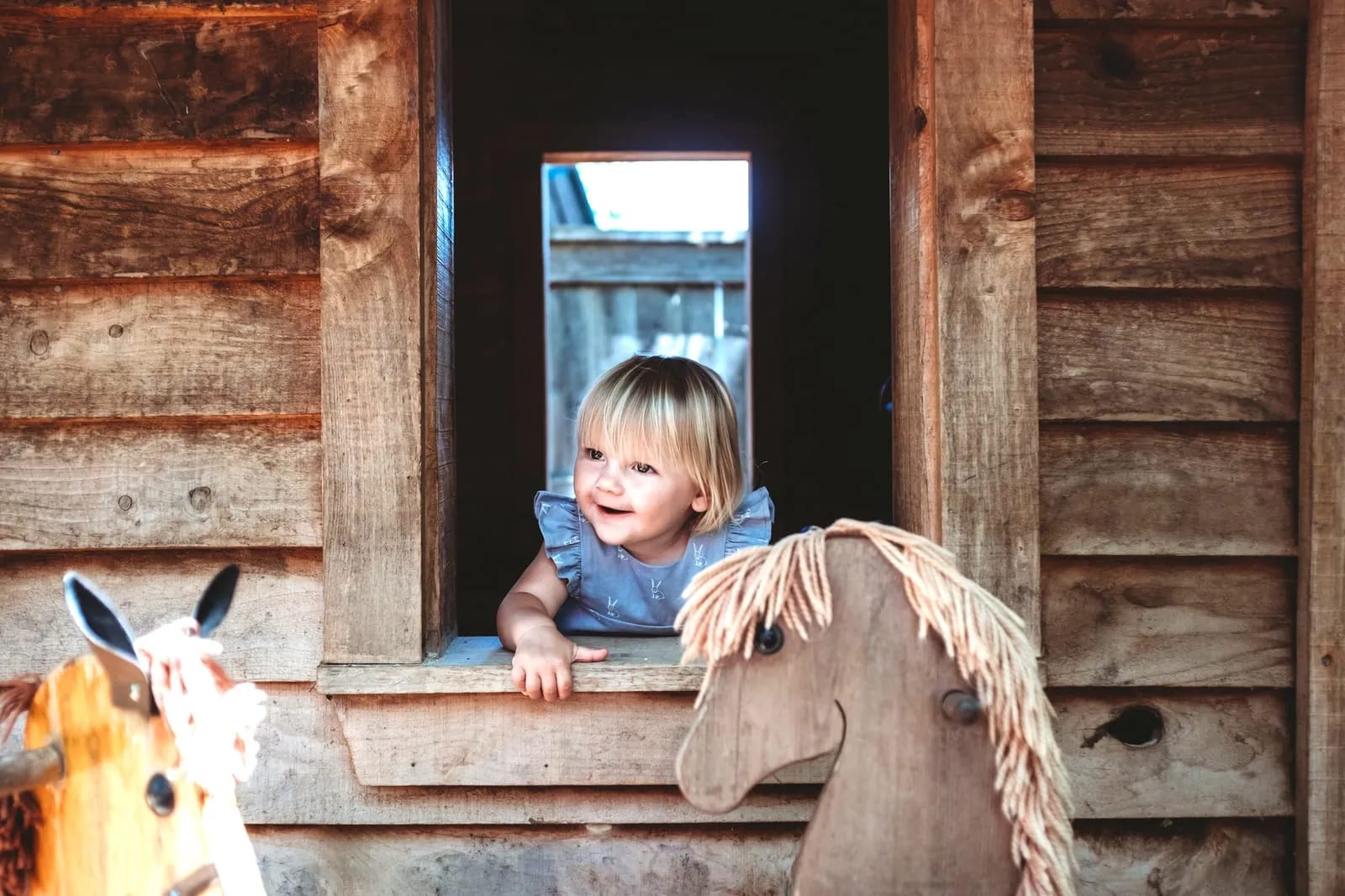 girl playing in playhouse