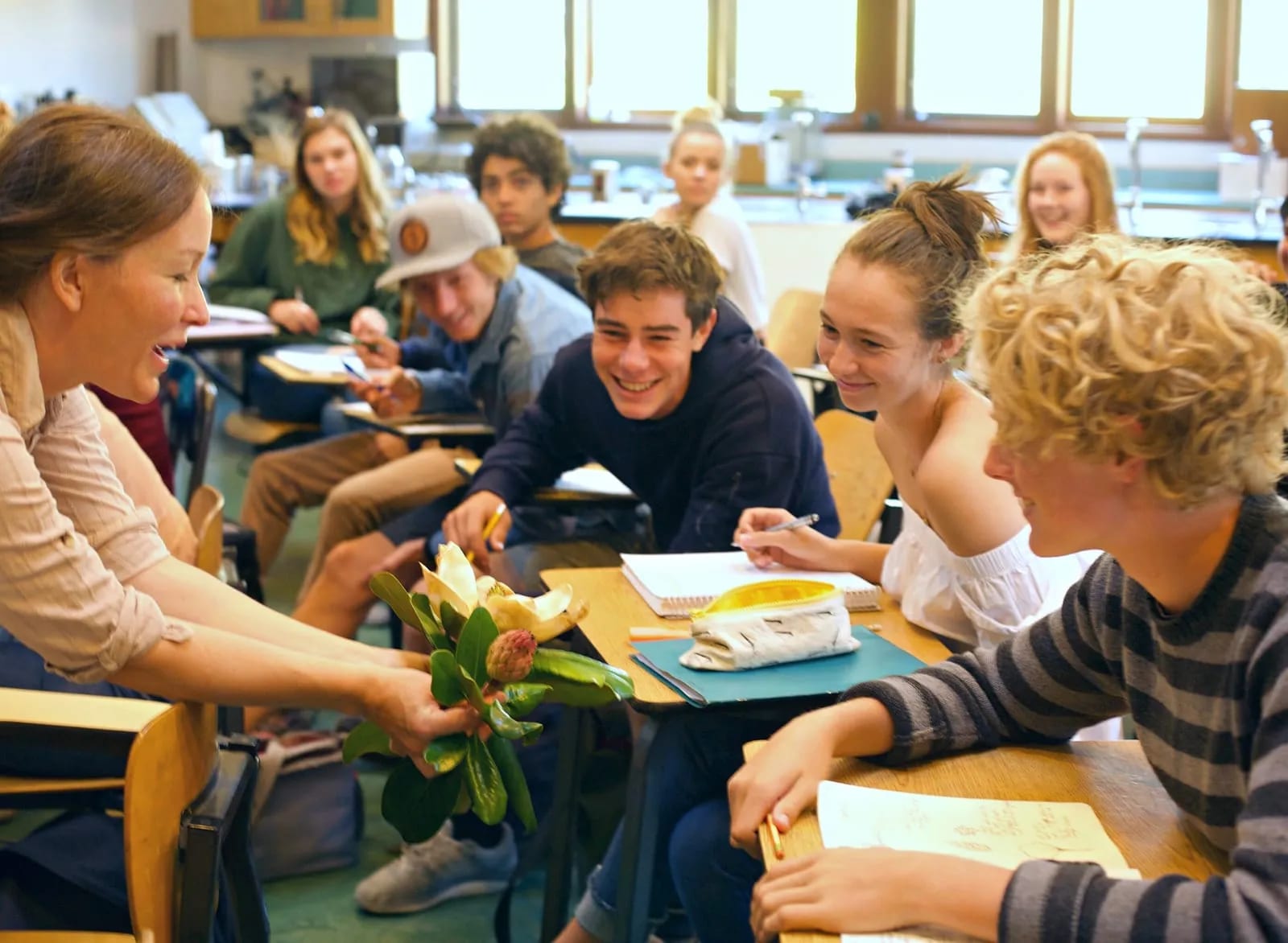 Teacher offering students flower
