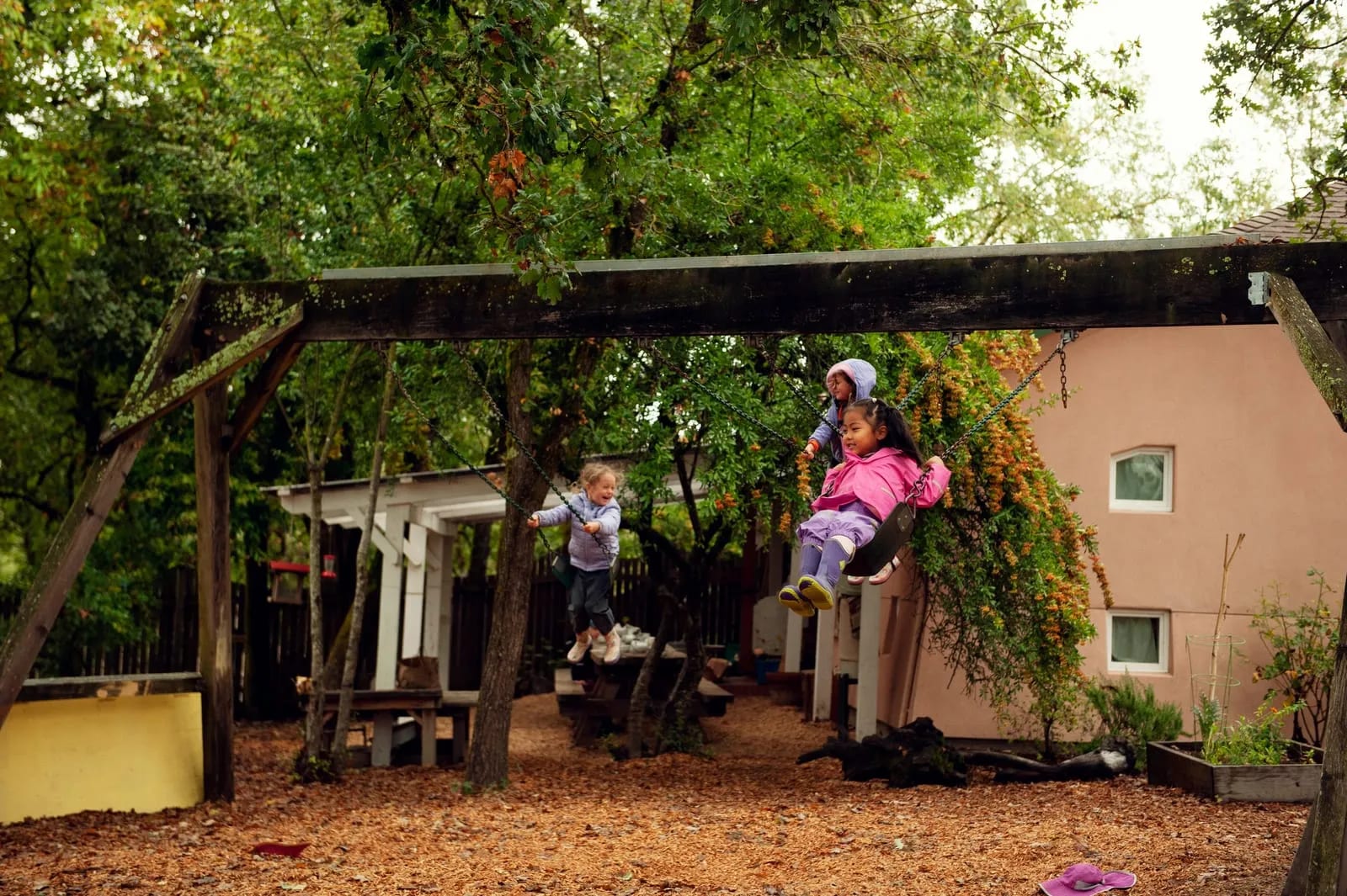 On the swings in the kindergarten yard.